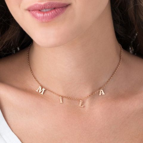 Dangling Family Initials Necklace in 18k gold-plated sterling silver, showing multiple letter charms (e.g., A, S, M) hanging from a delicate chain.