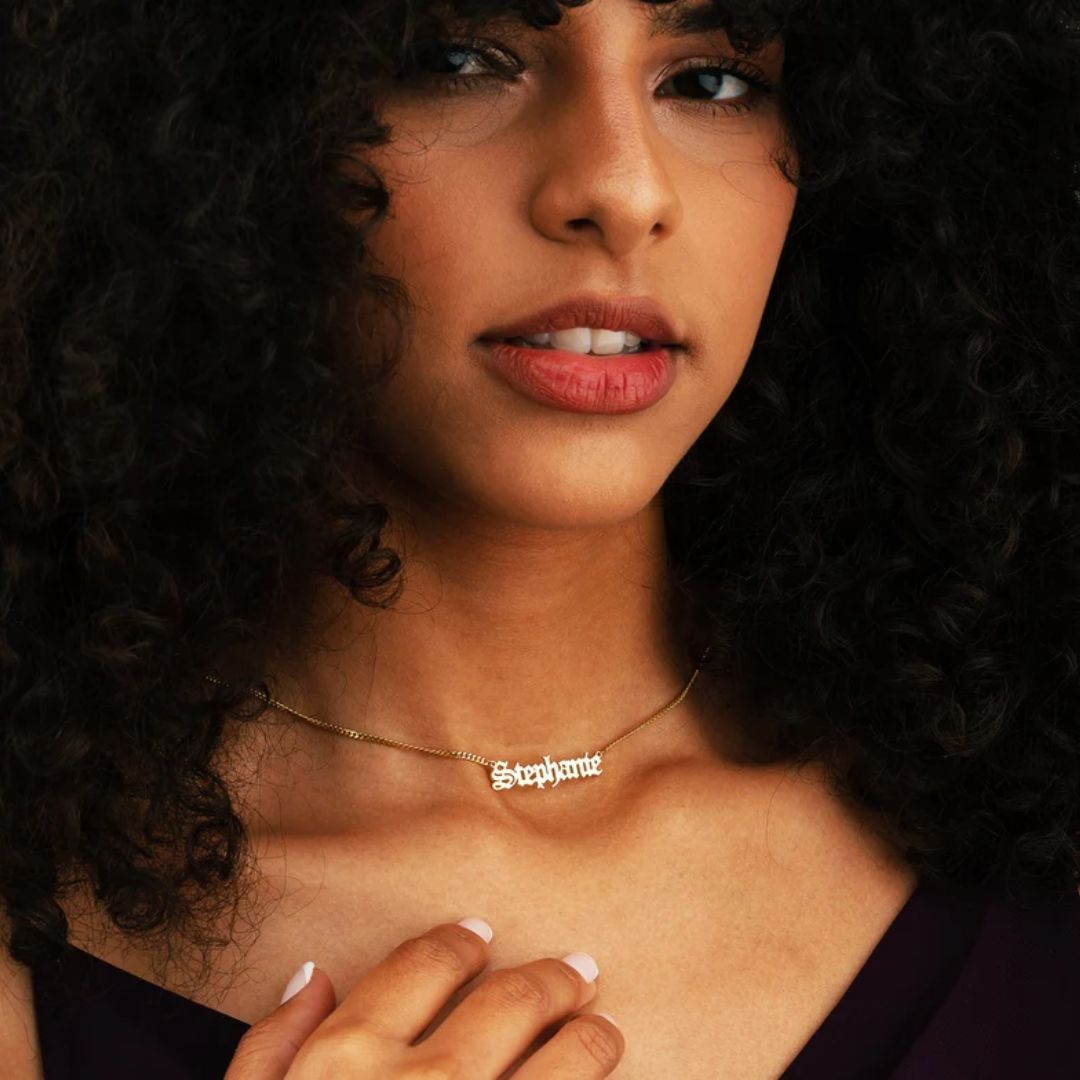 Gothic name necklace with the name 'Lilith' in Old English script, made from 18k rose gold-plated sterling silver on a curb chain.