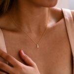 Dazzling pave initial 'M' necklace in 18k gold-plated sterling silver, sparkling on a delicate chain.