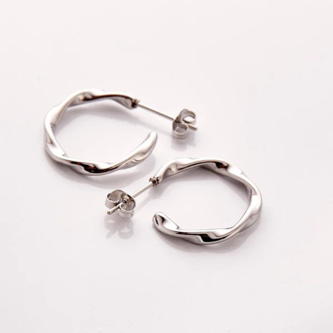 A pair of Liquid Ripple Hoop Earrings in 18k gold-plated sterling silver, showcasing their unique textured, light-catching surface.