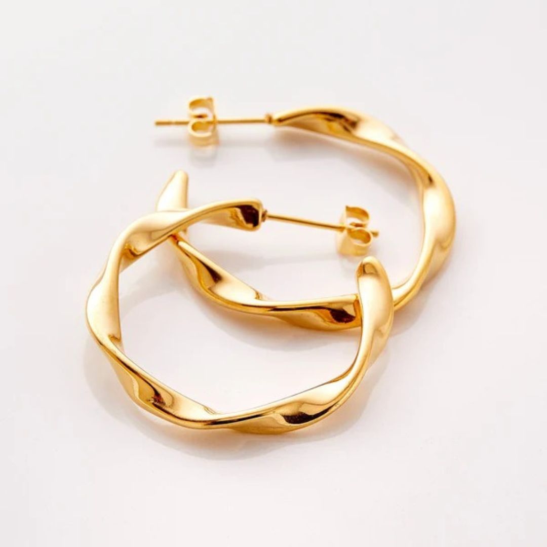 A pair of Liquid Ripple Hoop Earrings in 18k gold-plated sterling silver, showcasing their unique textured, light-catching surface.