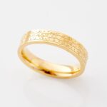 Ayatul Kursi ring in 18k gold-plated sterling silver, worn on a woman's finger to show the deeply engraved Arabic calligraphy of The Throne Verse.