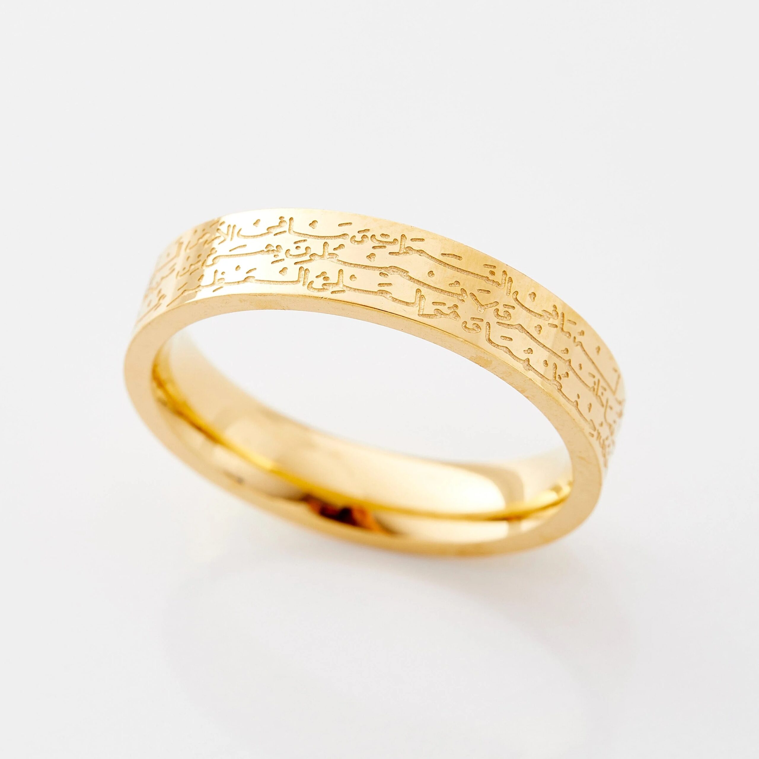 Ayatul Kursi ring in 18k gold-plated sterling silver, worn on a woman's finger to show the deeply engraved Arabic calligraphy of The Throne Verse.