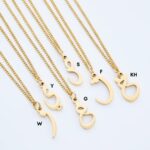 A floating Arabic initial 'S' (Seen) necklace in 18k gold-plated sterling silver, showing the unique sideways design of the letter integrated into the chain.