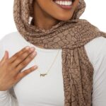 A personalized 'Jessica' name necklace in 18k gold-plated sterling silver, hanging from a delicate chain on a neutral background.