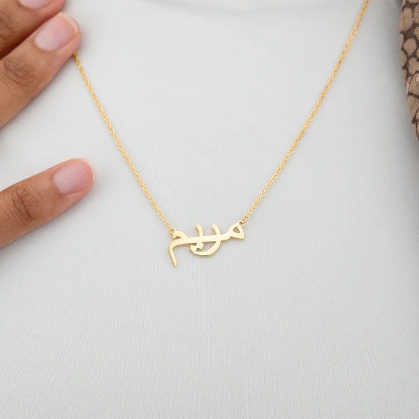 A personalized 'Jessica' name necklace in 18k gold-plated sterling silver, hanging from a delicate chain on a neutral background.
