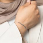 A Dainty Mama Script Bracelet in 18k gold-plated sterling silver, worn on a woman's wrist.