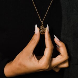 The Alhamdulillah calligraphy cradle necklace in 18k gold-plated sterling silver, showcasing the unique crescent design against a clean background.