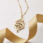 "I Am Near" Quranic verse bar necklace in 18k gold-plated sterling silver, showing the delicate Arabic calligraphy on the vertical pendant.