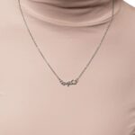 A 'Maktub' raised calligraphy necklace in 18k gold-plated sterling silver, showing the 3D effect of the Arabic script on the round medallion.
