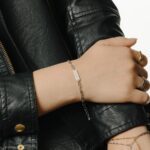 'Ukhti' Arabic calligraphy sister link bracelet in 18k gold-plated sterling silver, shown on a woman's wrist.