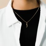 A floating Arabic initial 'S' (Seen) necklace in 18k gold-plated sterling silver, showing the unique sideways design of the letter integrated into the chain.