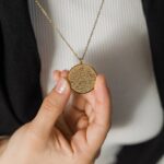 Close-up of an Ayatul Kursi bar necklace in 18k rose gold-plated sterling silver, showcasing the intricate Arabic engraving of The Throne Verse.