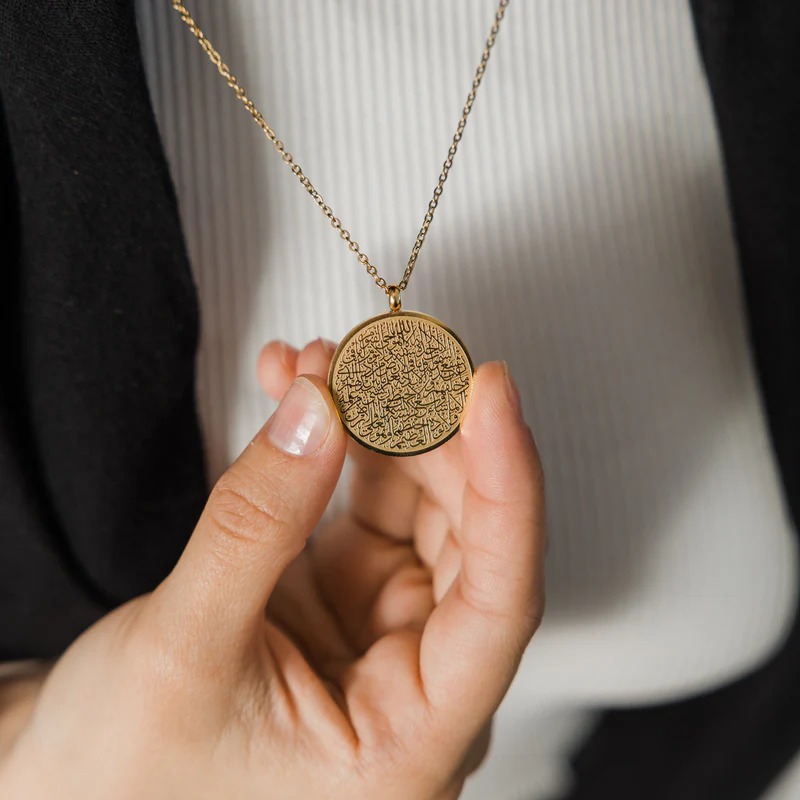 Close-up of an Ayatul Kursi bar necklace in 18k rose gold-plated sterling silver, showcasing the intricate Arabic engraving of The Throne Verse.