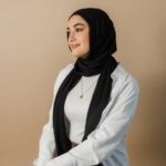 Arabic initial 'A' (Alif) letter necklace in 18k gold-plated sterling silver, hanging from a delicate chain on a plain background.