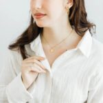 Arabic initial 'A' (Alif) letter necklace in 18k gold-plated sterling silver, hanging from a delicate chain on a plain background.