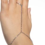 A woman's hand wearing the Twisted Rope Hand Chain in 18k gold-plated sterling silver, showing the delicate rope chain draping over the hand.