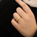"With Hardship Comes Ease" engraved ring in 18k gold-plated sterling silver, worn on a finger to show the Arabic calligraphy band.