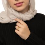 "With Hardship Comes Ease" engraved ring in 18k gold-plated sterling silver, worn on a finger to show the Arabic calligraphy band.
