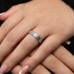 "With Hardship Comes Ease" engraved ring in 18k gold-plated sterling silver, worn on a finger to show the Arabic calligraphy band.