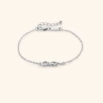 'Mama' Arabic calligraphy bracelet in 18k gold-plated sterling silver, worn on a woman's wrist, showing the delicate script.