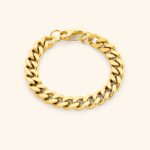 A woman's wrist wearing the bold Cuban link bracelet in 18k gold-plated sterling silver, showing the chunky, interlocking design.