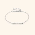 A Dainty Mama Script Bracelet in 18k gold-plated sterling silver, worn on a woman's wrist.