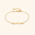 A Dainty Mama Script Bracelet in 18k gold-plated sterling silver, worn on a woman's wrist.