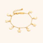 A delicate Celestial Moon and Star link bracelet in 18k gold-plated sterling silver, worn on a woman's wrist.