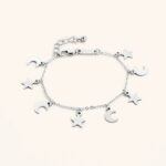 A delicate Celestial Moon and Star link bracelet in 18k gold-plated sterling silver, worn on a woman's wrist.