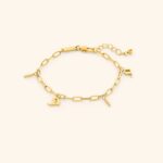 A woman's wrist wearing the Mama Charm Link Bracelet in 18k gold-plated sterling silver, showing the repeating engraved "Mama" medallions.