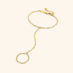 A woman's hand wearing the Twisted Rope Hand Chain in 18k gold-plated sterling silver, showing the delicate rope chain draping over the hand.