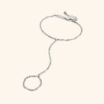 A woman's hand wearing the Twisted Rope Hand Chain in 18k gold-plated sterling silver, showing the delicate rope chain draping over the hand.