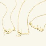 A personalized 'Jessica' name necklace in 18k gold-plated sterling silver, hanging from a delicate chain on a neutral background.