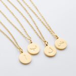 Arabic initial 'A' (Alif) letter necklace in 18k gold-plated sterling silver, hanging from a delicate chain on a plain background.