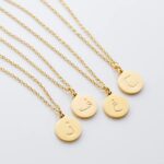 Arabic initial 'A' (Alif) letter necklace in 18k gold-plated sterling silver, hanging from a delicate chain on a plain background.