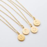 Arabic initial 'A' (Alif) letter necklace in 18k gold-plated sterling silver, hanging from a delicate chain on a plain background.