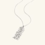 "With Hardship Comes Ease" medallion necklace in 18k gold-plated sterling silver, showcasing the intricate Arabic calligraphy engraving.