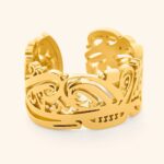 'Yusr' (Ease) Arabic calligraphy signet ring in 18k gold-plated sterling silver, worn on a finger to showcase the engraved face.