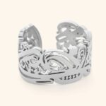 'Yusr' (Ease) Arabic calligraphy signet ring in 18k gold-plated sterling silver, worn on a finger to showcase the engraved face.