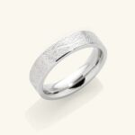 "With Hardship Comes Ease" engraved ring in 18k gold-plated sterling silver, worn on a finger to show the Arabic calligraphy band.