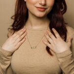 A vertical Shahada bar necklace in 18k gold-plated sterling silver, showing the clear Arabic calligraphy of the Islamic declaration of faith.