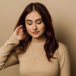 A vertical Shahada bar necklace in 18k gold-plated sterling silver, showing the clear Arabic calligraphy of the Islamic declaration of faith.